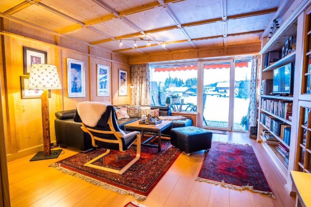 a living room with a couch and a table at Haus Lundsör by MoniCare in Seefeld in Tirol