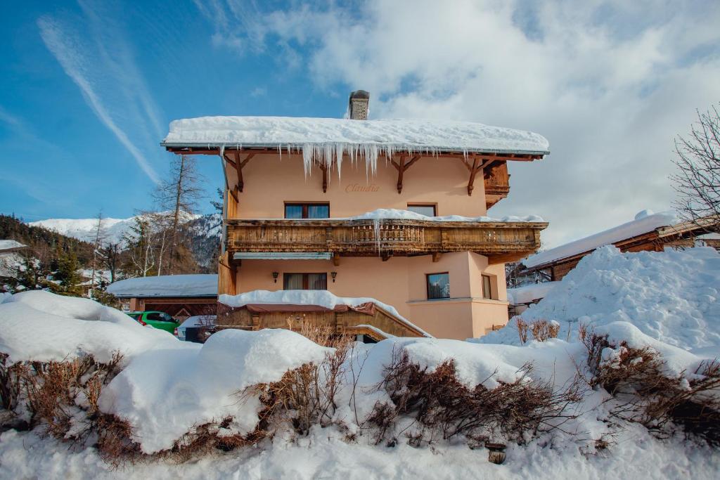 a building covered in snow with icicles on it at Appartement ERIKA by MoniCare (Haus Claudia) in Seefeld in Tirol