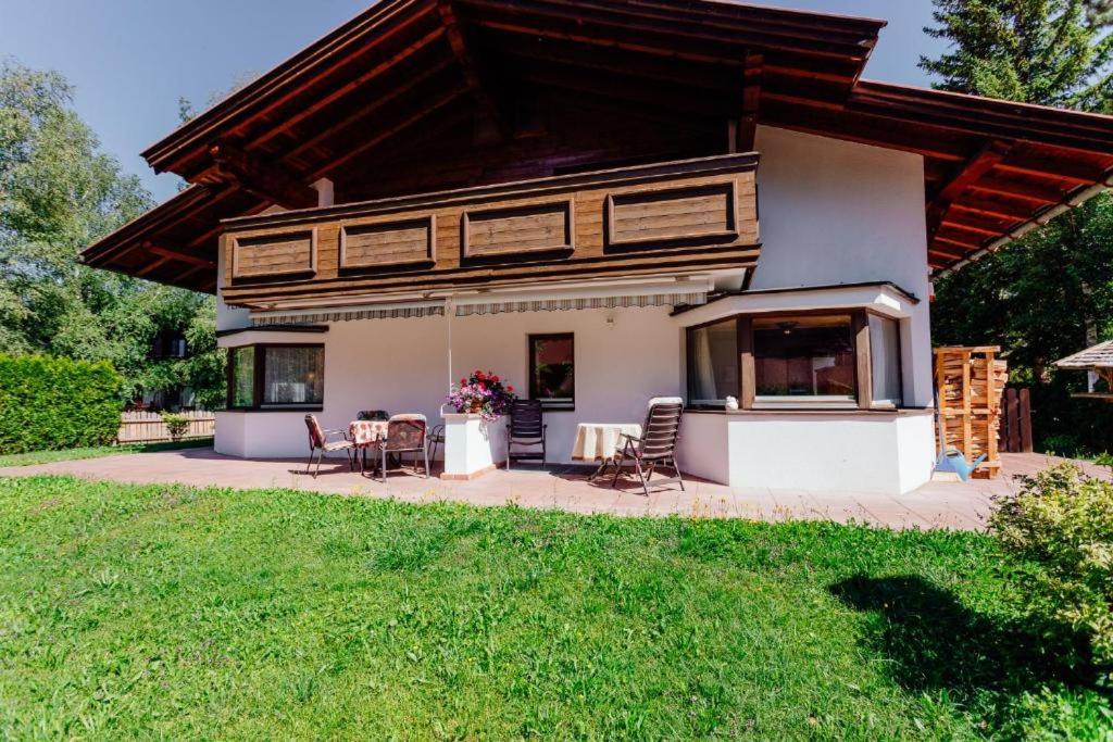 a house with a table and chairs in a yard at Haus ANNELIES Top 3 by Moni-care in Seefeld in Tirol