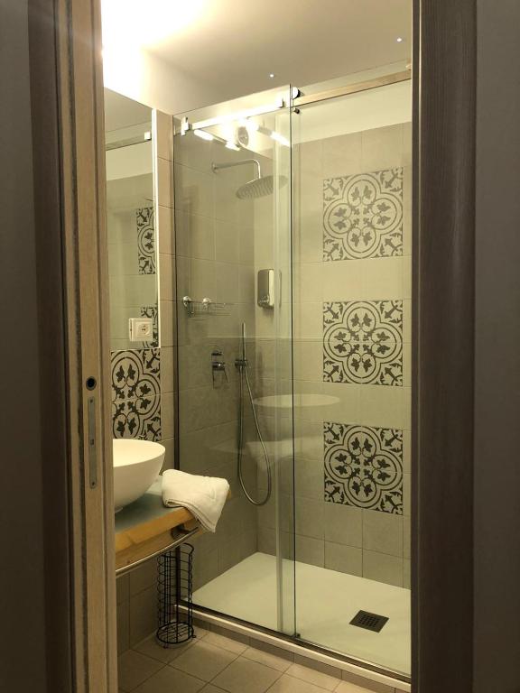 a bathroom with a glass shower and a sink at Ursino's Luxury in Catania