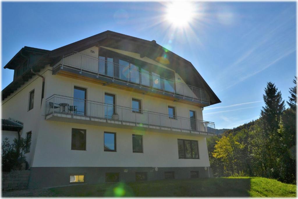 a building with a round roof with the sun behind it at Casa Bicicletta in Fuschl am See