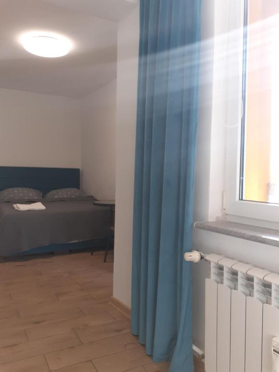 Posteľ alebo postele v izbe v ubytovaní APARTAMENTY CENTRUM PIŁSUDSKIEGO