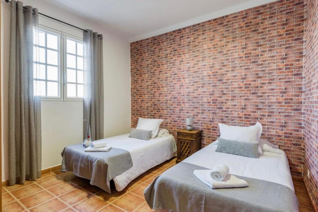 A bed or beds in a room at Pico Partido villa heated pool