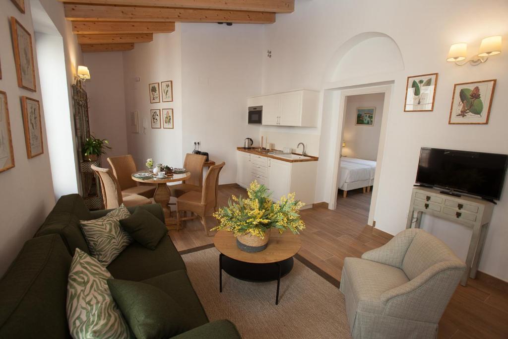 een woonkamer met een bank en een tafel bij Patios de la Riva in Jerez de la Frontera
