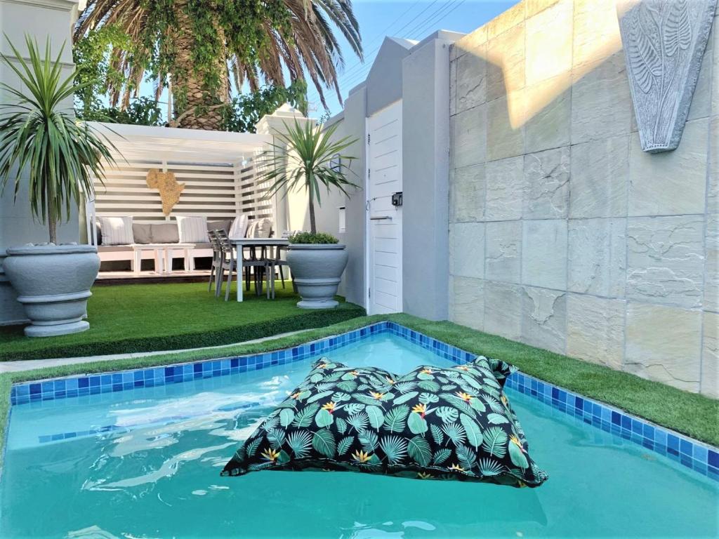 a swimming pool with a pillow in the middle of a house at 4 on Varneys Guest House in Cape Town