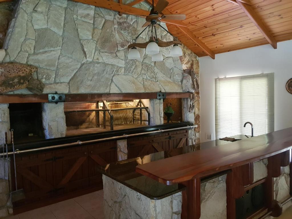 a kitchen with a stone wall and a table at La Deolinda in Funes