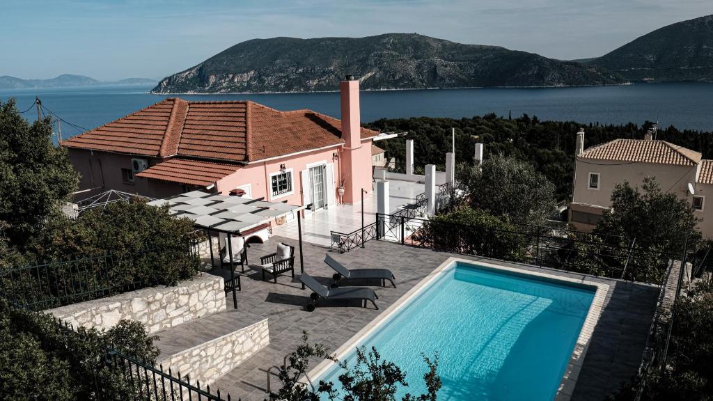 a house with a swimming pool in front of a house at Evreti Villa with Stunning views, near Fiscardo in Fiskardho