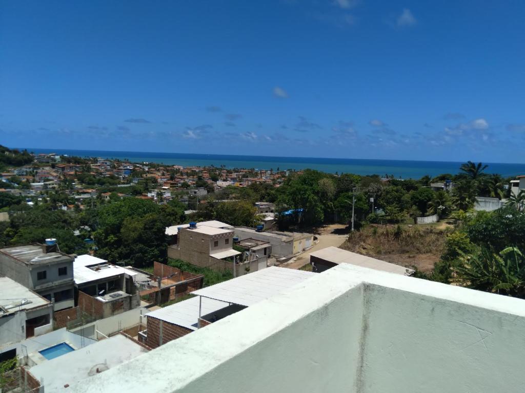 a view of a city and the ocean from a building at Kitnet 2,vista fantastica in Cabo de Santo Agostinho