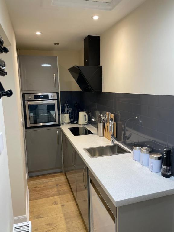 a kitchen with two sinks and a stove top oven at Loch Morar Private Suite in Mallaig