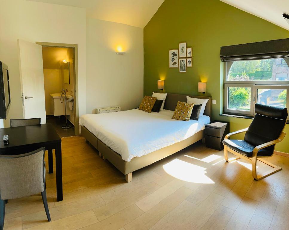 - une chambre avec un lit, un bureau et une chaise dans l'établissement Hotel Bibois, à Oud-Heverlee