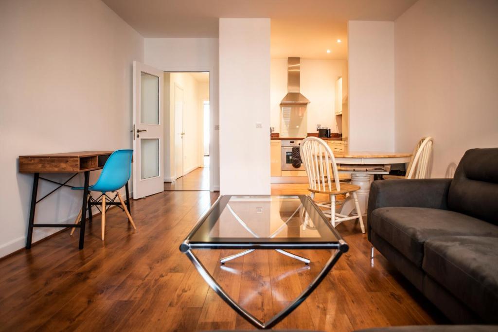 a living room with a glass table and a couch at The Forum in Dublin