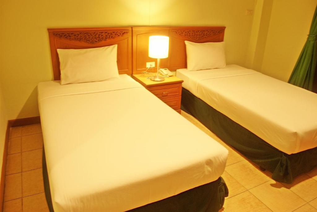 Postel nebo postele na pokoji v ubytování Golden Villa Pattaya
