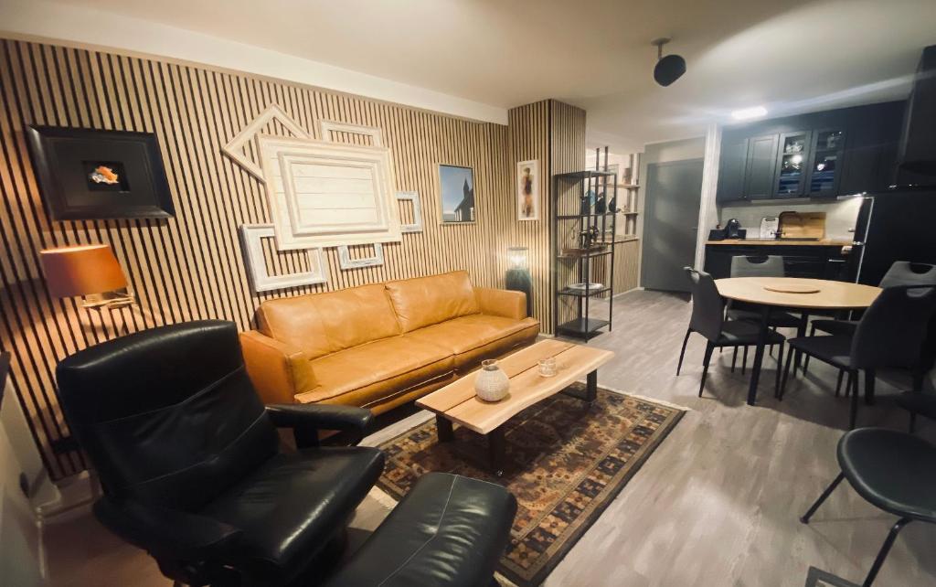 a living room with a couch and a table at Cosy Harbour Apartment in Reykjavík