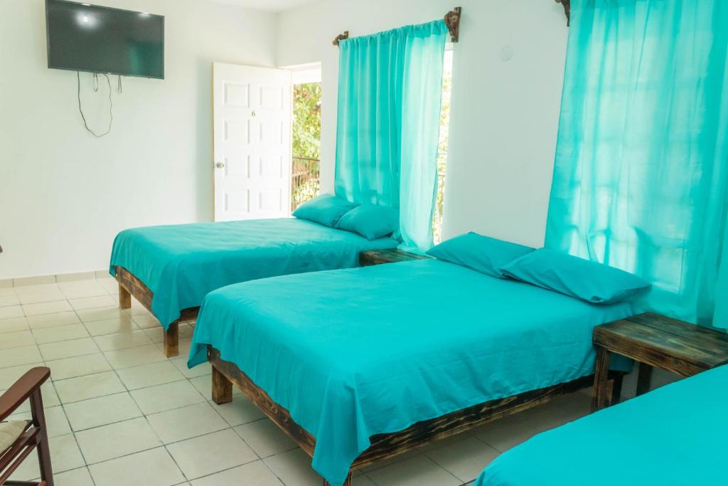 Postel nebo postele na pokoji v ubytování Hotel Henry Bacalar