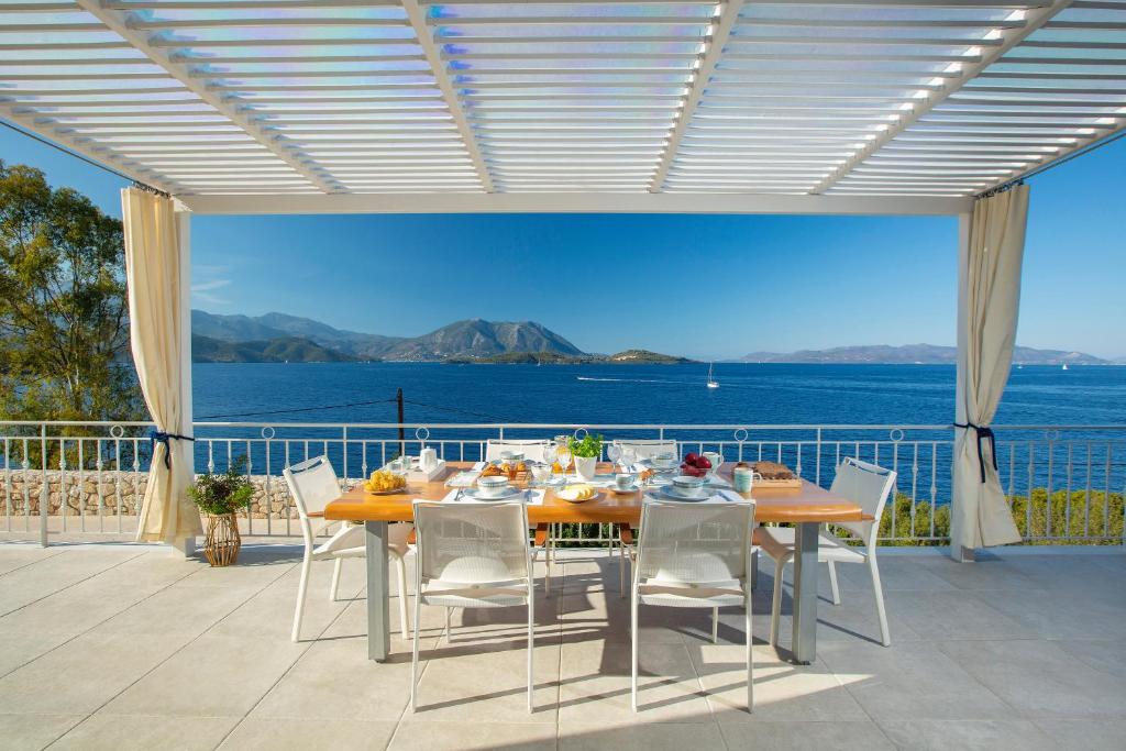 a dining table on a patio with a view of the ocean at Kavos House in Spartokhórion