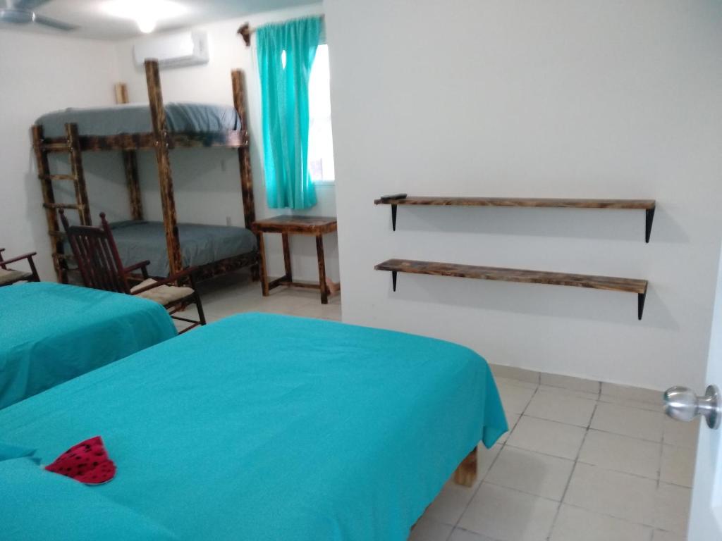 Postel nebo postele na pokoji v ubytování Hotel Henry Bacalar