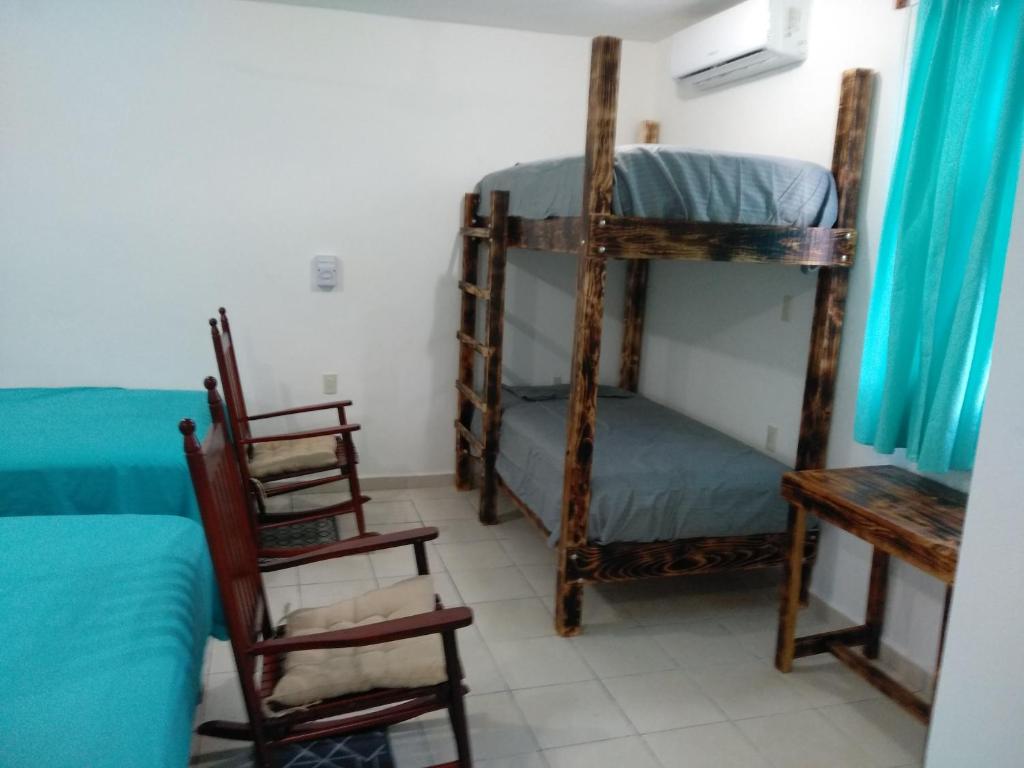 Postel nebo postele na pokoji v ubytování Hotel Henry Bacalar
