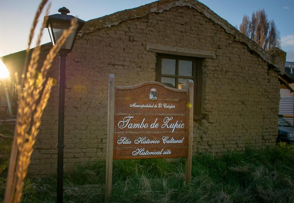 a sign in front of a brick building at Tambo Aparts in El Calafate