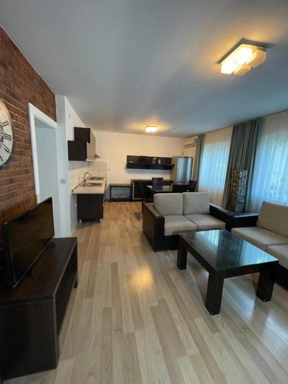 a living room with a couch and a table at Exclusive 9- Urban apartments in Kočani