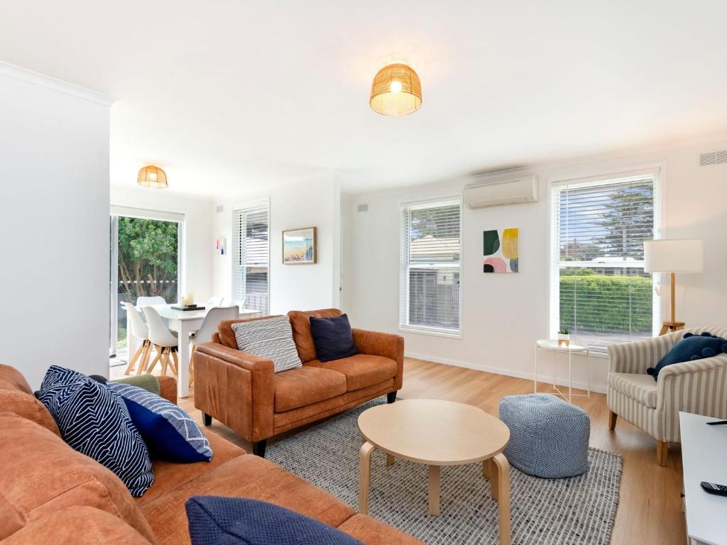 a living room with a couch and chairs and a table at MaryMae in Port Fairy