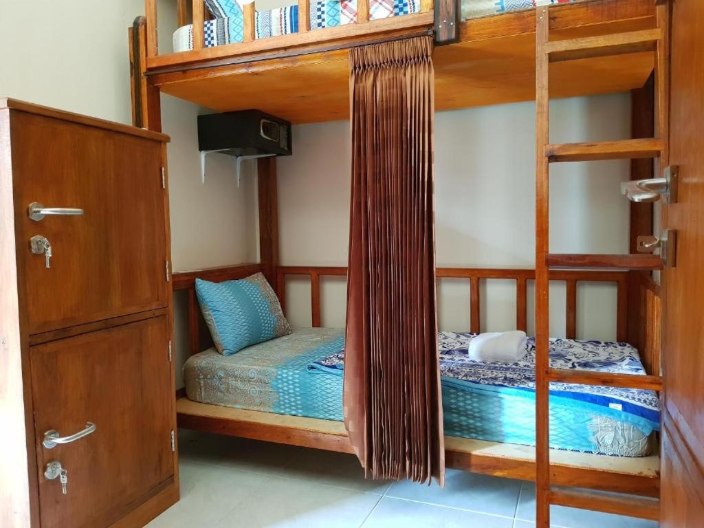 Postel nebo postele na pokoji v ubytování BANYU URIP ROOMS