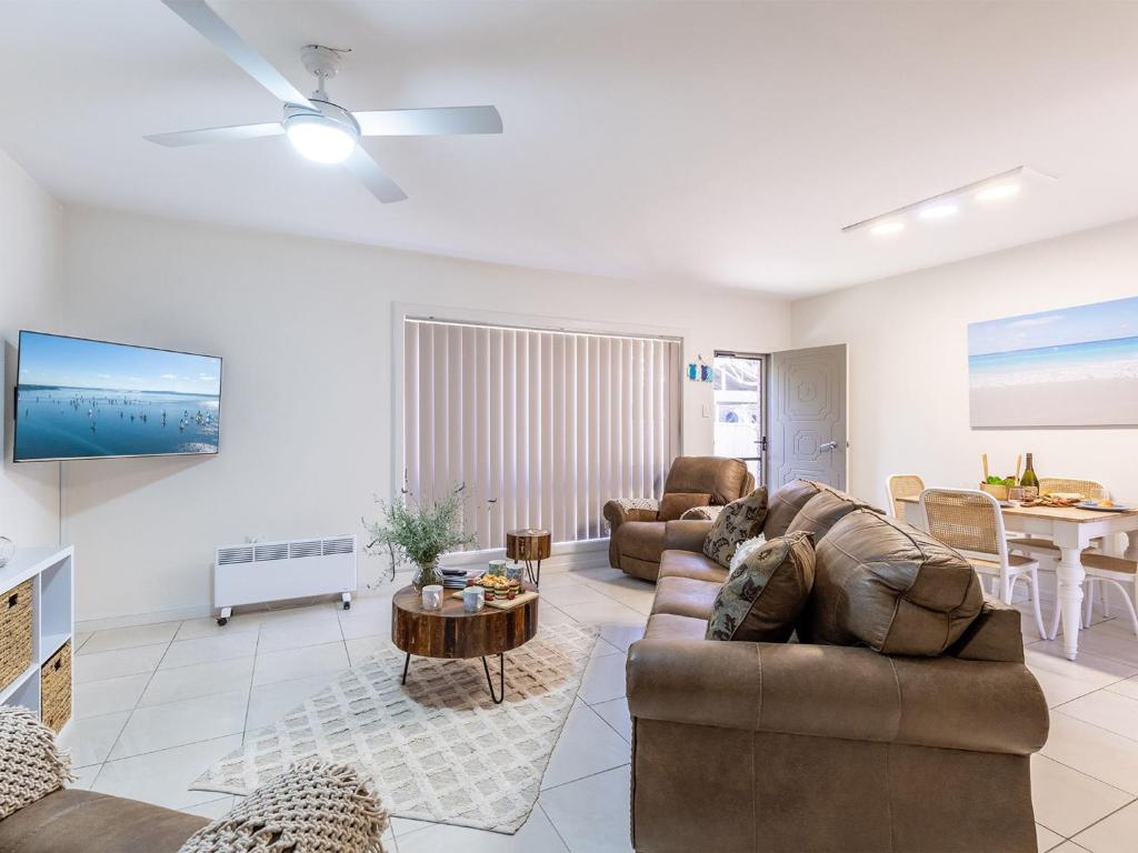 a living room with a couch and a table at Fingal Court 2 2 Lentara St in Fingal Bay