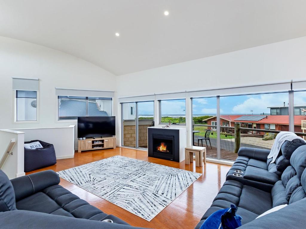 a living room with a couch and a fireplace at Southern Waves in Port Fairy