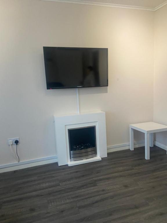 uma sala de estar com lareira e televisão de ecrã plano em Chalet hemsby em Great Yarmouth