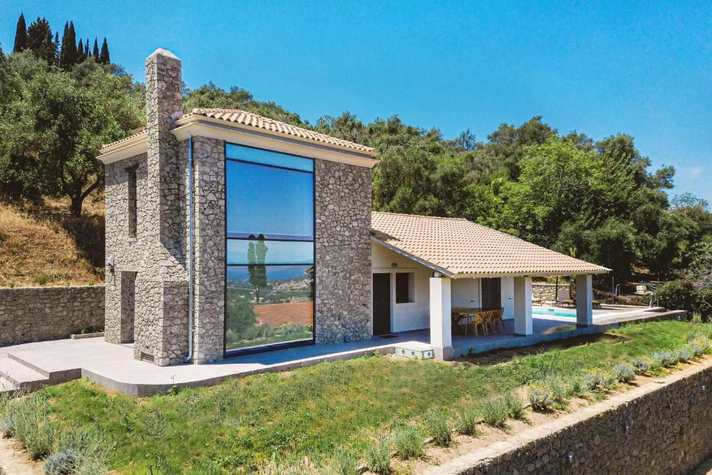 a house with a large window on the side of it at Villa Barocco Corfu in Kamára