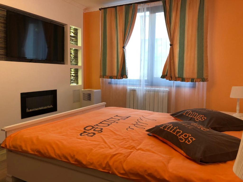 a bedroom with an orange bed with a sign on it at Vibe studio in Piatra Neamţ