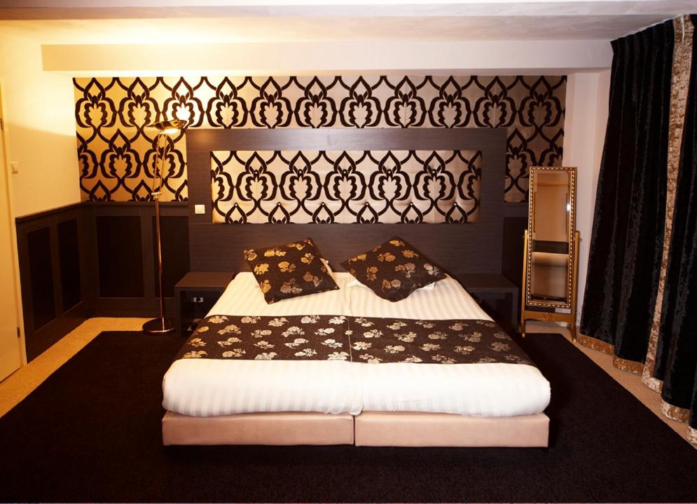 a bedroom with a large bed with pillows on it at Hotel 74 in Amsterdam