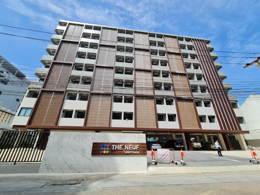 a large building with a sign in front of it at The Neuf@Ratchada in Bangkok