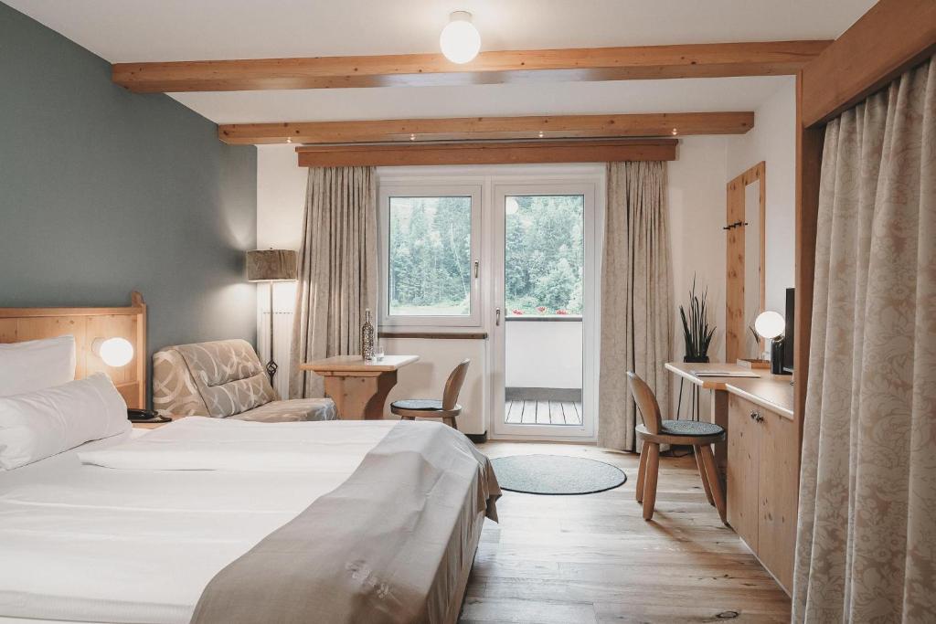 Postel nebo postele na pokoji v ubytování Hotel & Appartements Tiroler Buam