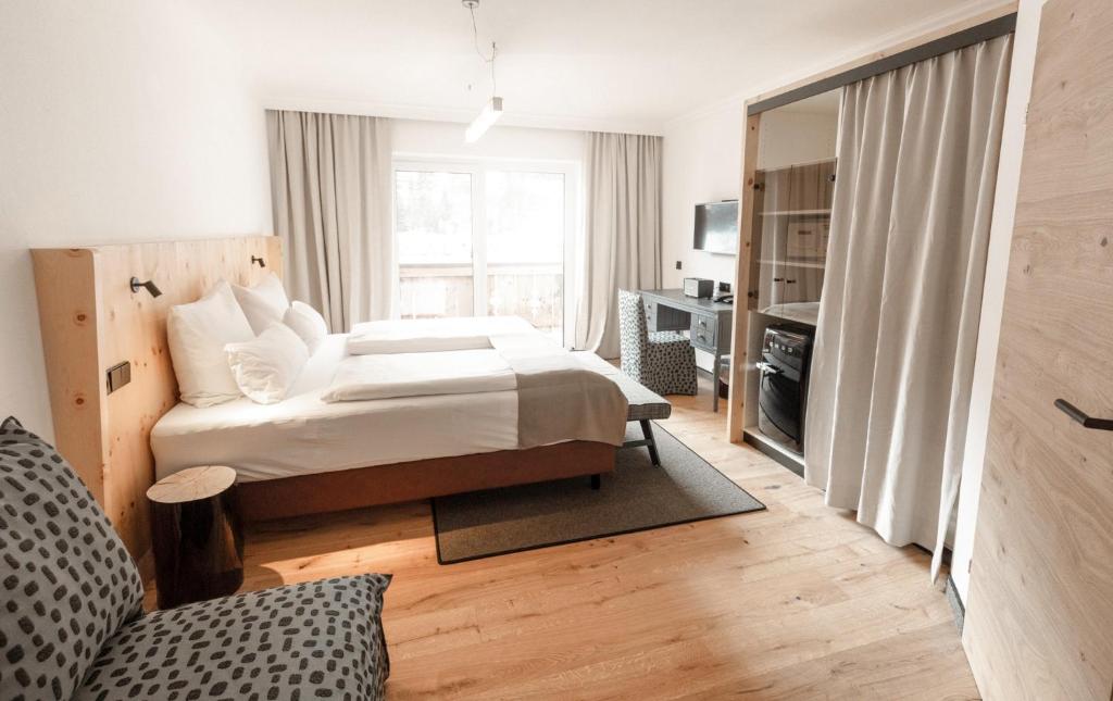 Postel nebo postele na pokoji v ubytování Hotel & Appartements Tiroler Buam