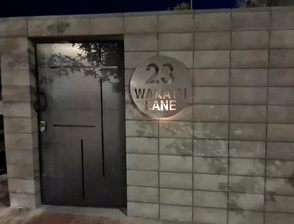 a door with a sign that reads walk in one at Oaktree House in Nelson