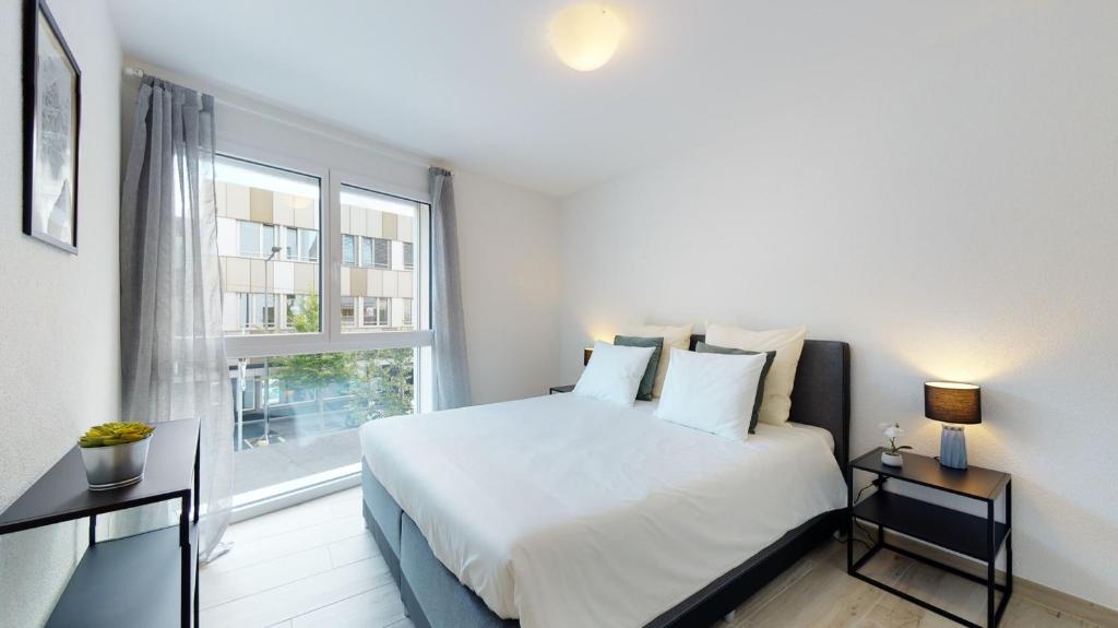 Uma cama ou camas num quarto em Nonanteneuf appart hōtel Aigle - contactless check-in