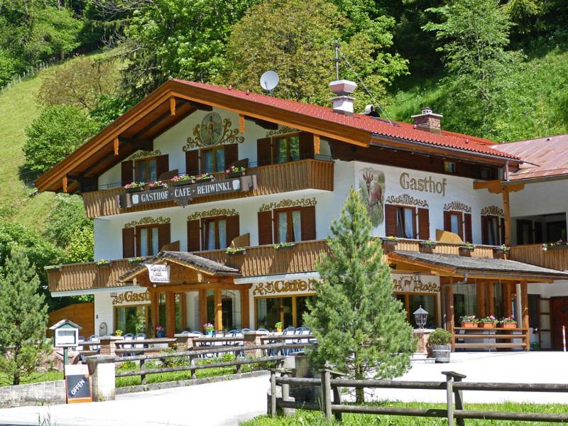 a large building with a fence in front of it at Gasthof Rehwinkl in Ramsau