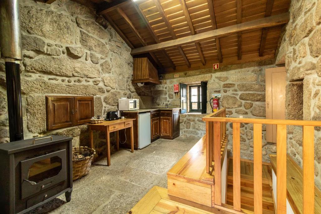 cocina con fogones y pared de piedra en Soajo Casa de Campo (PNPG), en Soajo