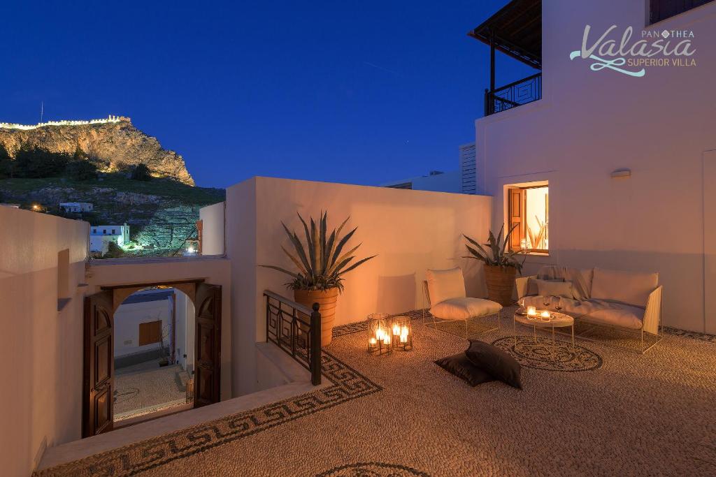 a house with a living room with a fireplace at Panthea Valasia Boutique Villa in Líndos