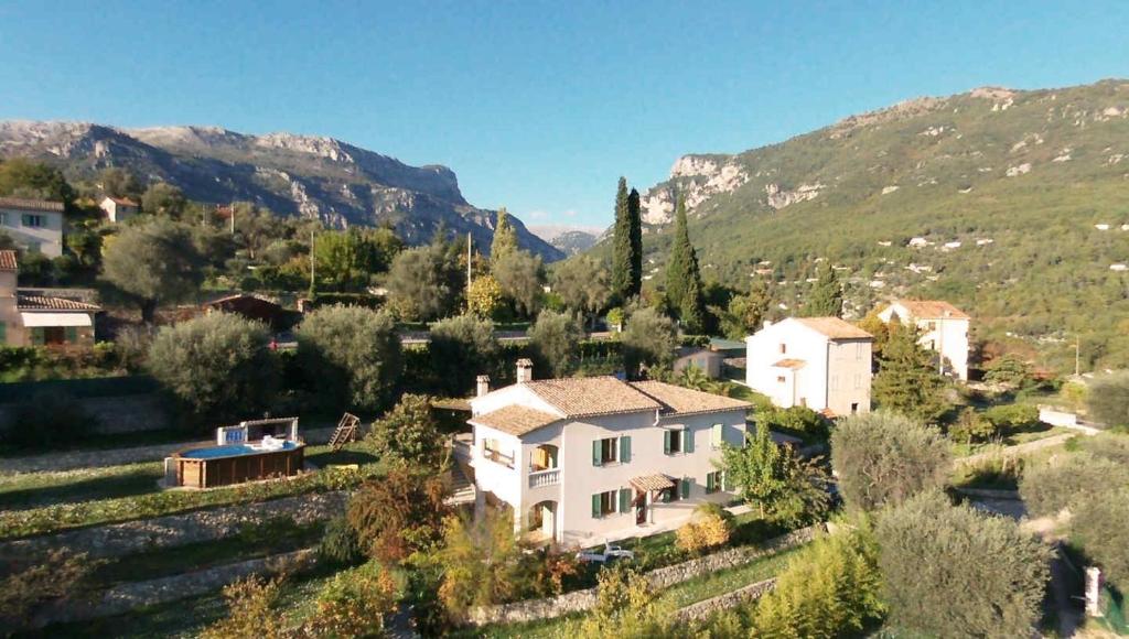 an aerial view of a house with mountains in the background at Locations-06 la Pascaline in Le Bar-sur-Loup