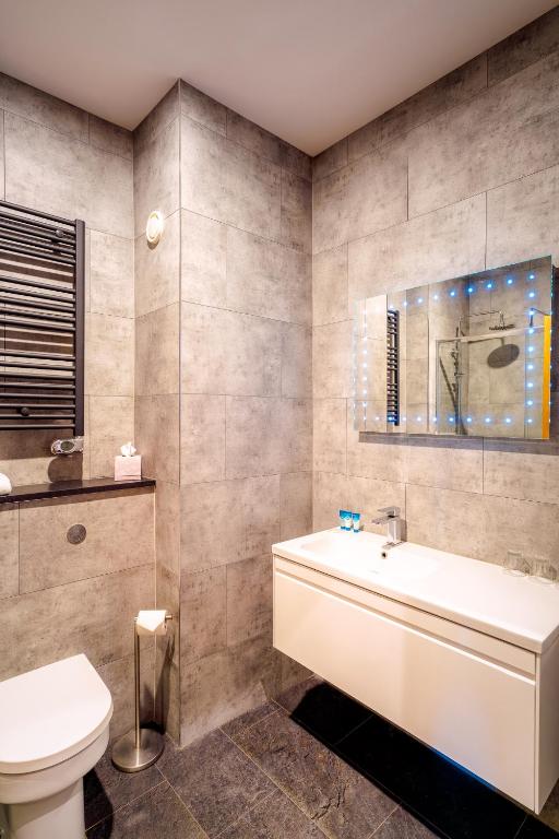 a bathroom with a tub and a toilet and a sink at Portrush Atlantic Hotel in Portrush