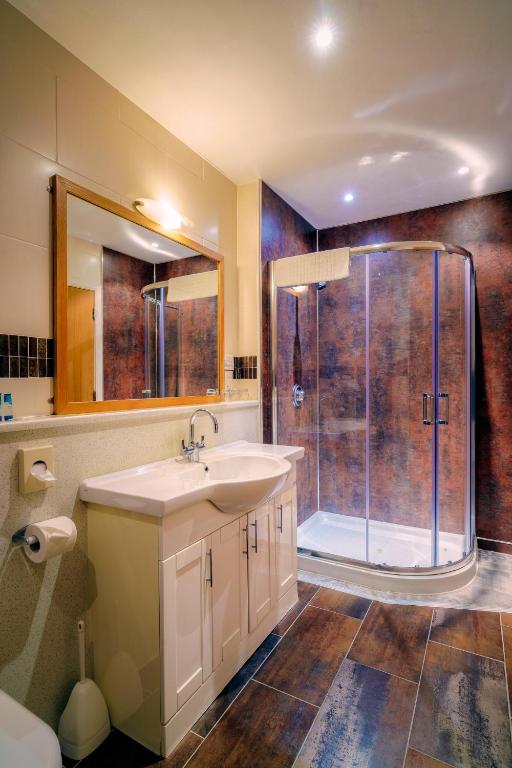 a bathroom with a sink and a shower at Portrush Atlantic Hotel in Portrush