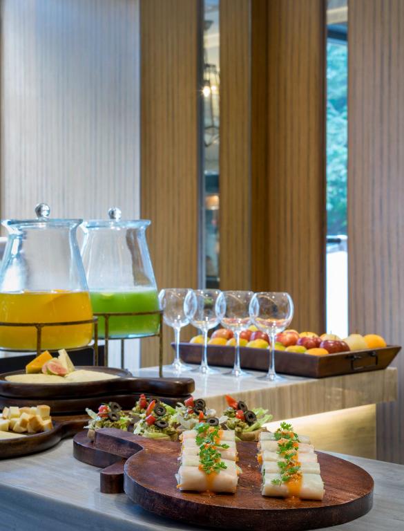 a table with plates of food and glasses of wine at The Raintree, St. Mary’s Road in Chennai
