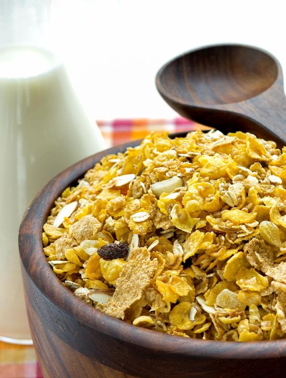 a wooden bowl of food with two wooden spoons at The Raintree, St. Mary’s Road in Chennai