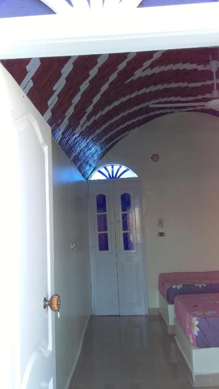 a room with a room with a bed and a door at Roma House in Aswan