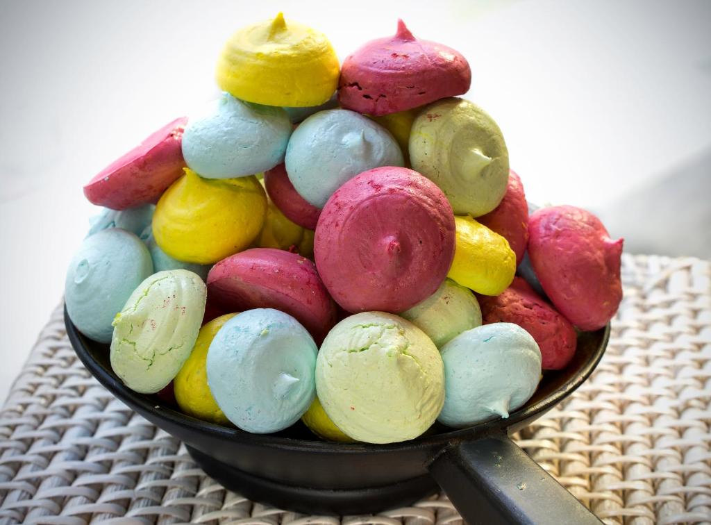 a bowl of different colored macaroons on a table at The Raintree, St. Mary’s Road in Chennai