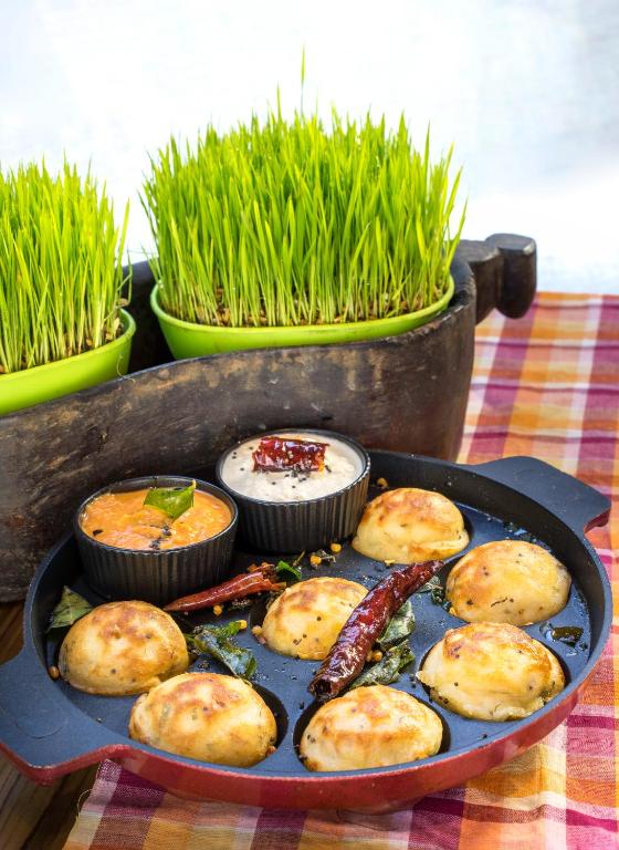 a pan filled with food on top of a table at The Raintree, St. Mary’s Road in Chennai