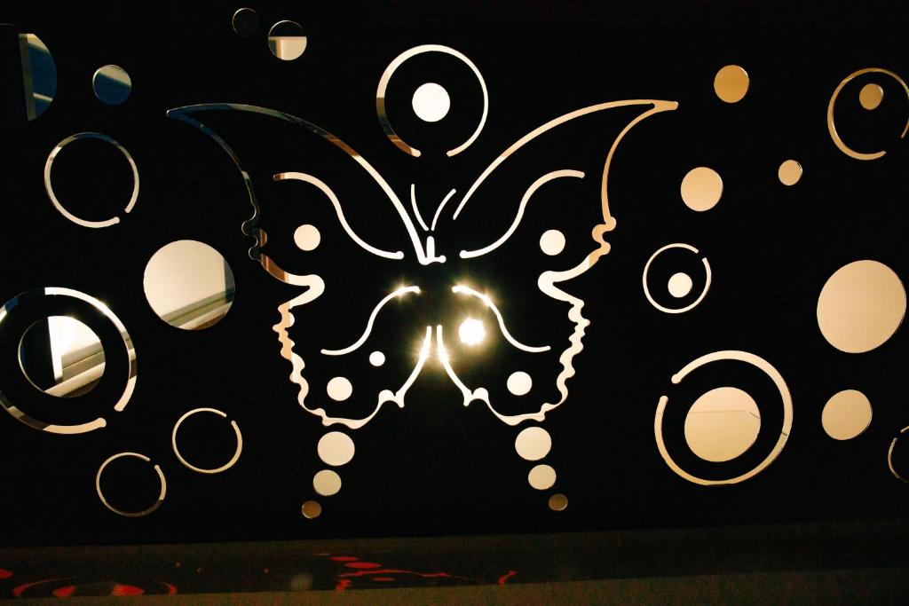 a butterfly decoration on a wall with lights at The Butterfly in Sângeorgiu de Mureș