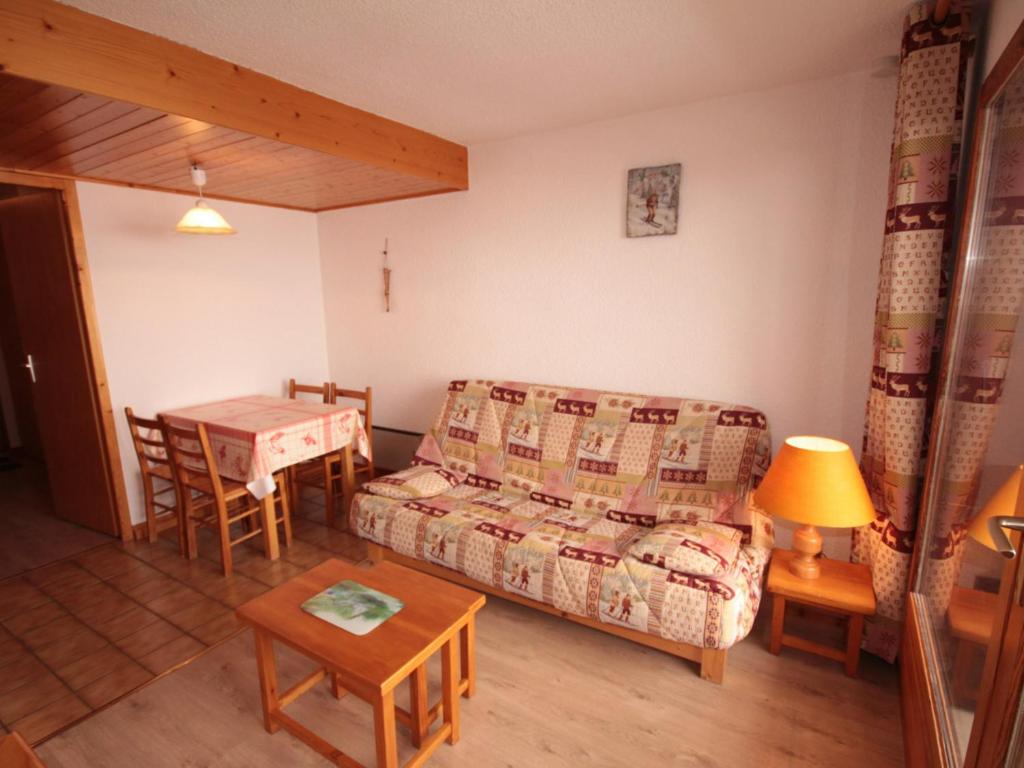 a living room with a couch and a table at Studio Les Saisies, 1 pièce, 4 personnes - FR-1-293-177 in Les Saisies