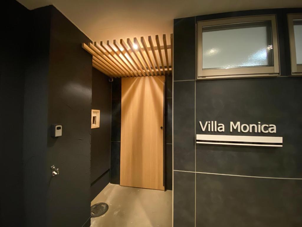 a bathroom with a sign that reads villa monica at Villa Monica in Nagoya
